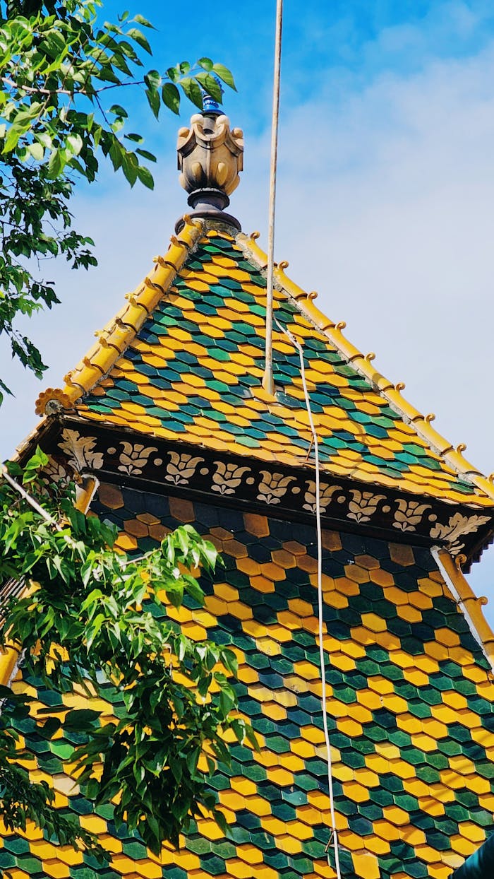 Vibrant green and yellow tiled roof on a Zsolnay building in Pécs, Hungary.